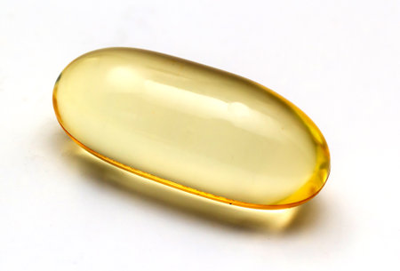 Fish oil capsules omega 3 on light background. Transparent yellow capsules of fish oil.の写真素材