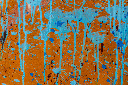 White plastered wall splattered with red paint. Paint splashes on the wall. Painted poster wall. Abstract background. Painted plaster texture.の写真素材