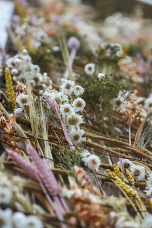 A close-up view reveals a colorful assortment of dried flowers artistically arranged, highlighting the beauty of nature on a clear, sunny day.の写真素材