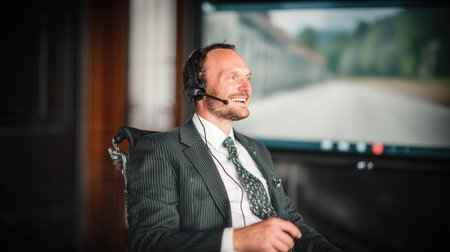 Business professional in a wheelchair is actively participating in a video call smiling and dressed in a suit demonstrating a positive attitude and professionalism.の素材