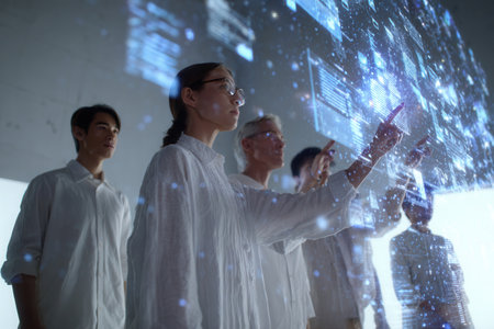 A team of scientists in white lab coats engages with a high-tech interface showing data in a modern lab boosting their research collaboration.の素材