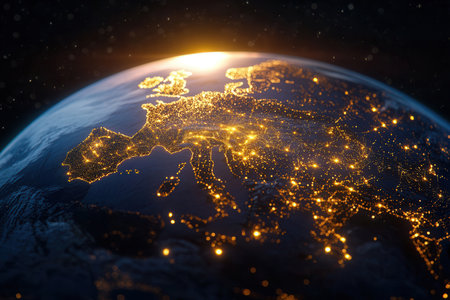 An illuminated globe displays air and sea transport routes over Europe showing the intricate connections between countries at twilight emphasizing global trade.の素材