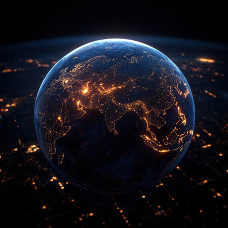 A glowing globe shows illuminated city lights across continents depicting a detailed and vibrant view of Earth at night against a black background.の素材