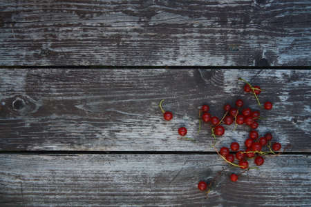 Fresh Redcurrant with Leaves on Gray Wooden Backgroundの写真素材