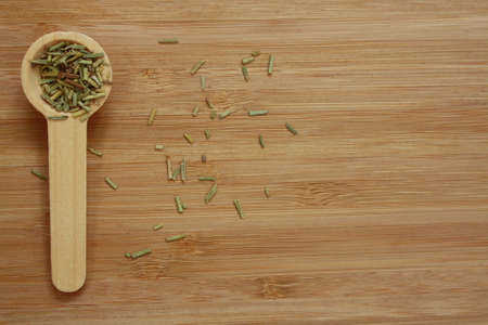 Dried rosemary in the wooden spoonの写真素材