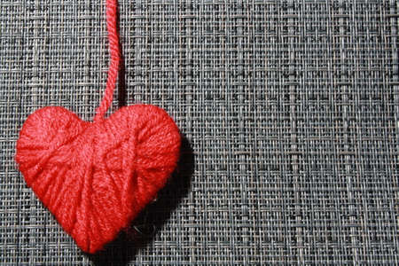 hart made of yarn isolated on gray background