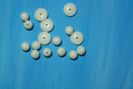 White beads on the blue backgroundの写真素材