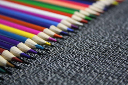 wooden color pencils on a gray background