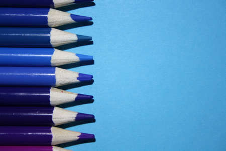 wooden color pencils on a blue backgroundの写真素材