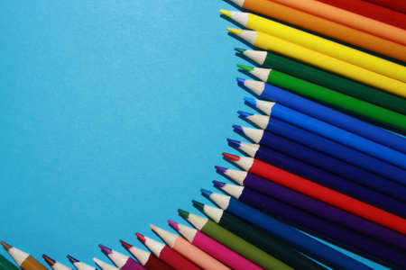 wooden color pencils on a blue backgroundの写真素材