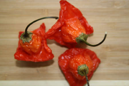 Red peppers on a wooden table