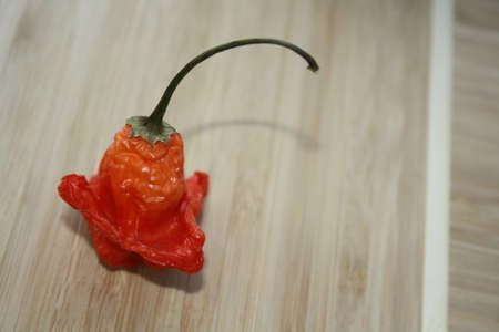 Red peppers on a wooden tableの写真素材