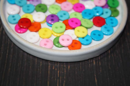 Colorful button on a brown background