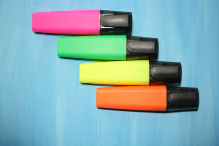highlighters isolated on a blue background