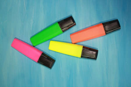 highlighters isolated on a blue backgroundの写真素材