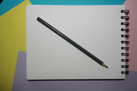 Notebook blank page, colorful pencils. Background with copy space