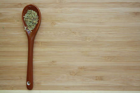 Spice rosemary in a ceramic spoon. Space of your text.