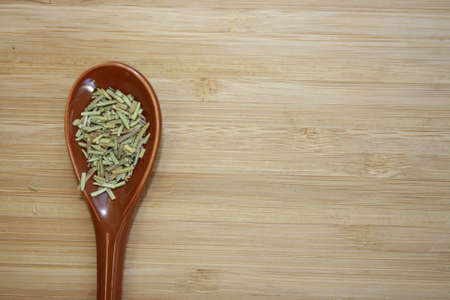 Spice rosemary in a ceramic spoon. Space of your text.の写真素材