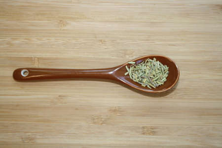Spice rosemary in a ceramic spoon. Space of your text.の写真素材