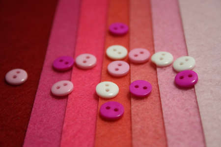 Colorful buttons on a pink felt background. Craftの写真素材