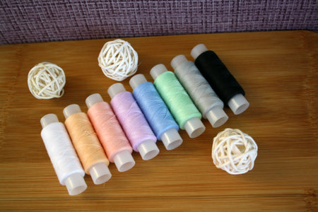 Colorful yarn on spool, cotton. Colorful sewing threads on white background. Space for text.