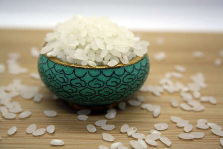 White rice for pilaf on a wooden background. Space for text.