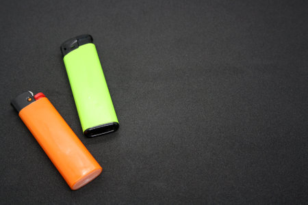 Two lighters on a black background.の写真素材