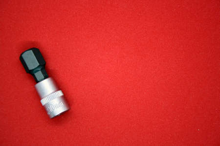 Bit for a screwdriver on a red background. Space for text.の写真素材