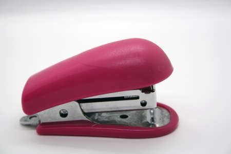 Pink stationery stapler on a white background. Space for text.の写真素材