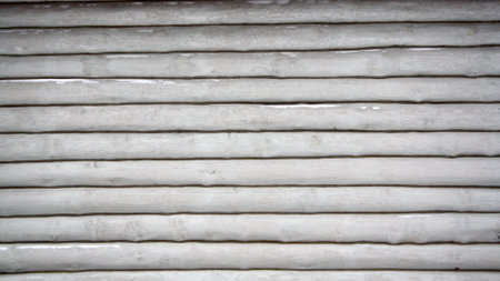 The gray log wall of the house. Background of logs. Space for text.の写真素材