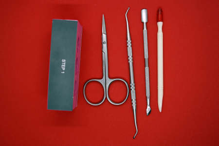 Manicure tools on a red background. Space for text.