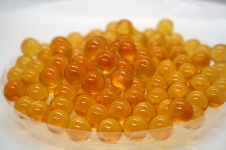 Fish oil capsules on white background. Space for text.