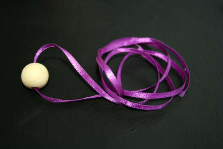Wooden bead on a black background. Space for text.