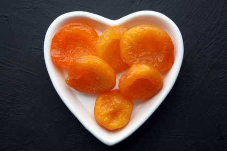 Dried apricots on a black background. Space for text.の写真素材