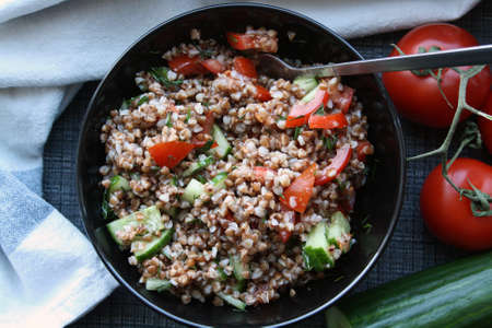 Salad of buckwheat, tomatoes, cucumbers and dill. Space for text.