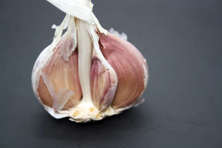 Garlic heads on a black background. Space for text.