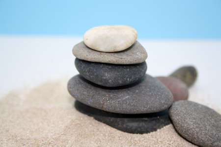 Sea round stones on the fine sand. Selective focus. Space for text.