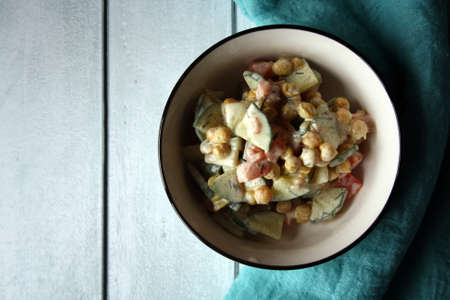 Chickpeas, tomatoes, cucumbers. Salad in a white bowl. Culinary background.の写真素材