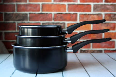 Ladles for cooking on a wooden table.