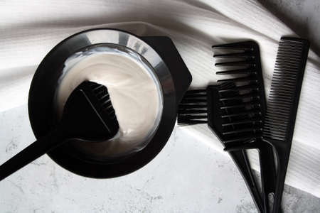 Professional hair dresser tools with copy space. Brush, comb, hair dye in a bowl.の写真素材