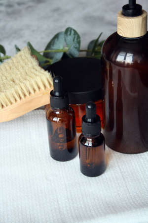 Set of brown glass cosmetic bottles. Skin care, organic body treatment, spa concept.