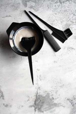 Professional hair dresser tools with copy space. Brush, comb, hair dye in a bowl.の写真素材