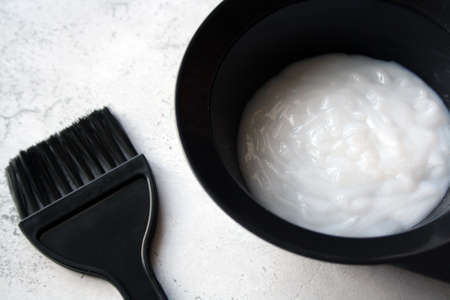 Professional hair dresser tools with copy space. Brush, hair dye in a bowl.の写真素材