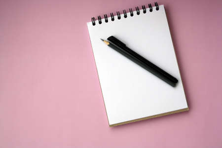 Planner layout, open blank spiral notebook for design, lettering, text, template. Pink background, pen, pencil. Space for text.の写真素材