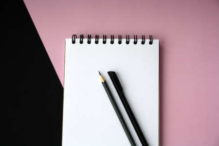 Planner layout, open blank spiral notebook for design, lettering, text, template. Pink background, pen, pencil. Space for text.の写真素材