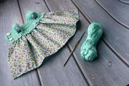 Crochet dress for a doll made of cotton yarn . Home needlework made of thread.の写真素材