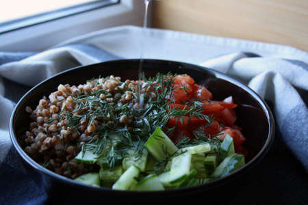 Salad of buckwheat, tomatoes, cucumbers and dill. Space for text.の写真素材