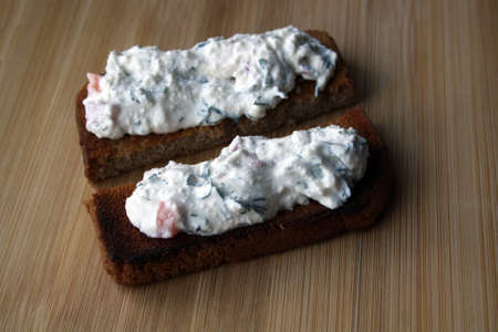 Cottage cheese dip and black bread toast. Breakfast. Space for text.の写真素材