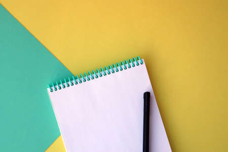 Planner layout, open blank spiral notebook for design, lettering, text, template. Yellow with green background, pen. Space for textの写真素材