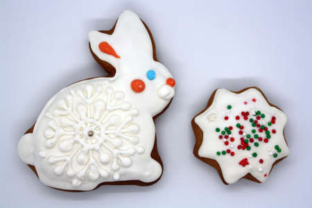 Gingerbread in the shape of a bunny covered with icing on a white background. Space for text.の写真素材